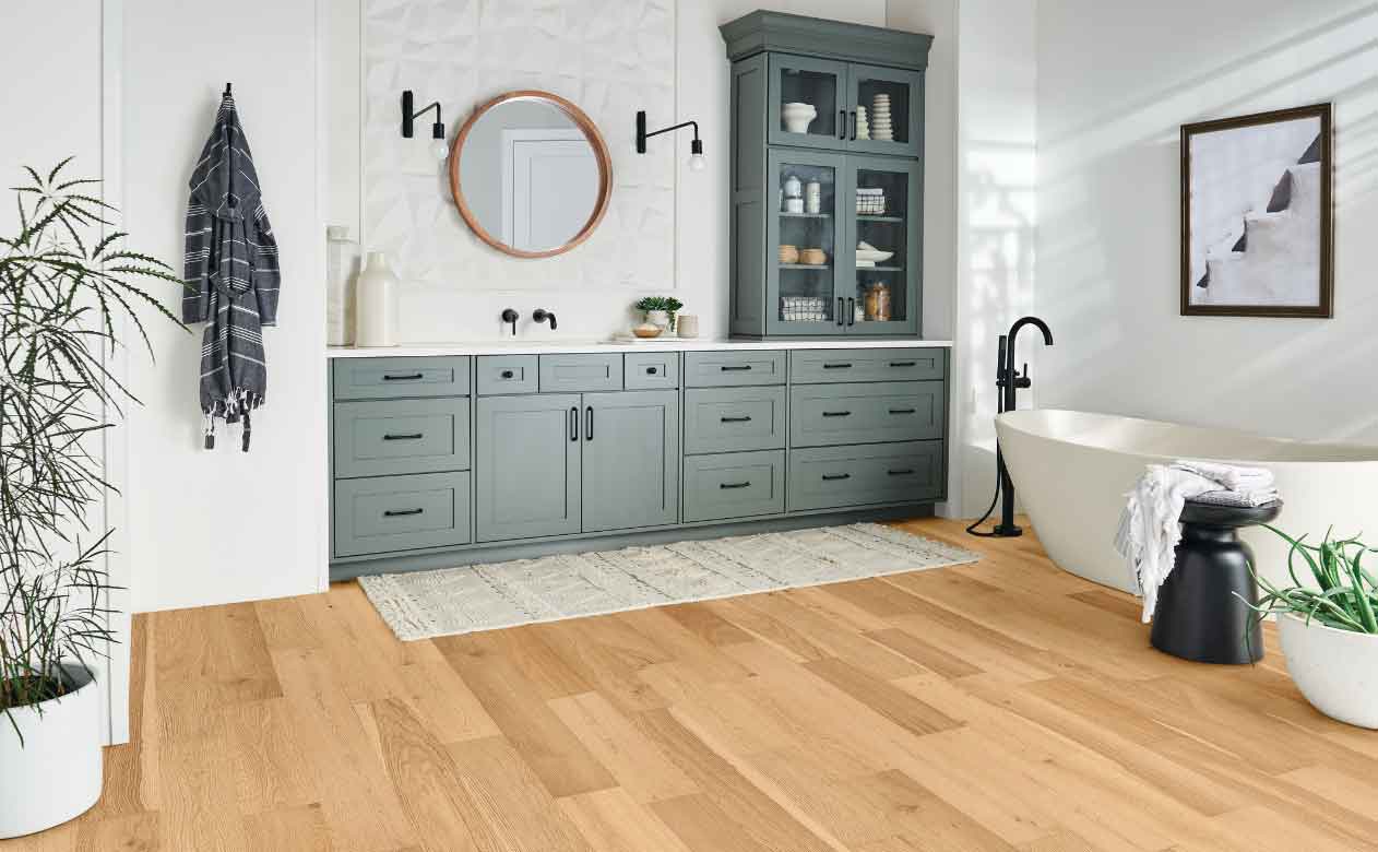 Hardwood Flooring in TN Bathroom with Tub, Sink, Mirror, and Cabinets