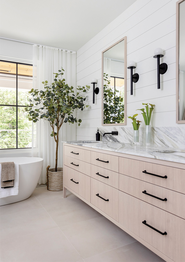 bathroom with marble countertop vanity and bath tub. Design by Knight Varga Interiors | Photography by Janis Nicolay